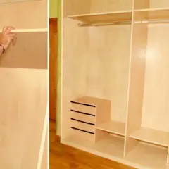 Man installing a shelf in a wooden closet, showing how to make a built-in wardrobe.