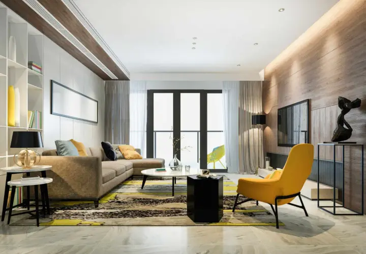 Un salón moderno con sofá marrón, alfombra llamativa y acentos amarillos. La iluminación indirecta en el techo y la pared de madera crea un ambiente cálido, ideal para saber como iluminar un salon.